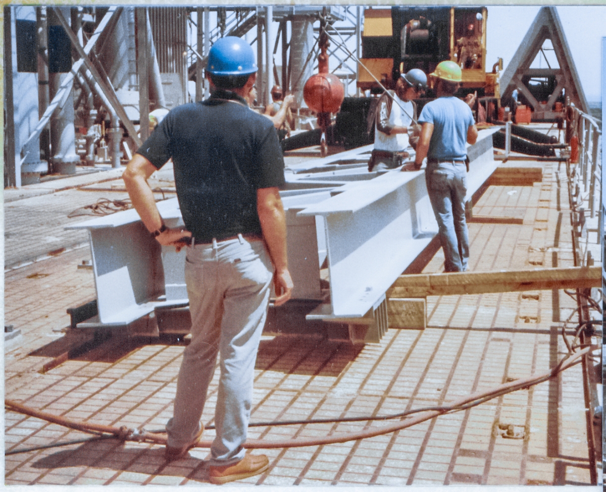 Wade Ivey watches over the assembly of a most unusual lifting sling, which will be used to carry the forty-foot long GOX Arm Strongback to a position 250' directly above where they're standing, where it will be connected the the top levels of the Fixed Service Structure at Launch Complex 39-B, Kennedy Space Center, Florida.